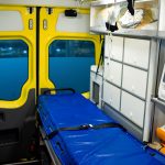 Interior of ambulance car with stretcher, refrigerator and medical equipment Interior of ambulance car with stretcher, refrigerator and medical equipment